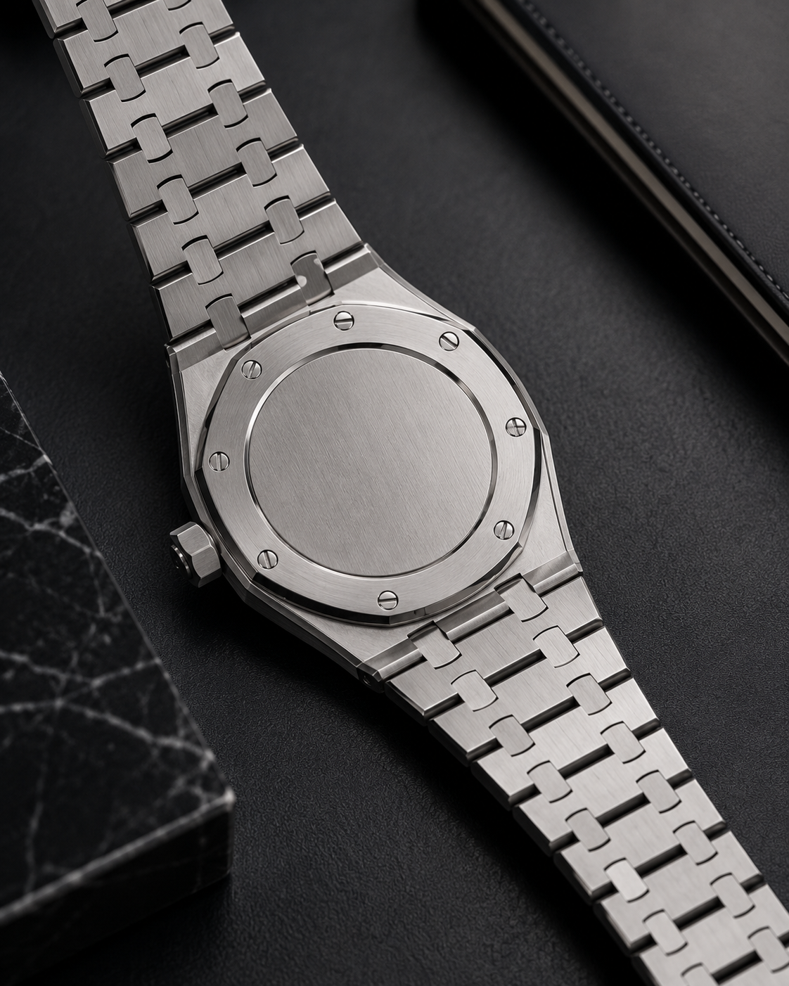 Caseback detail of The Royal — brushed steel and screwed bezel